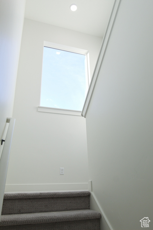 Stairway featuring recessed lighting