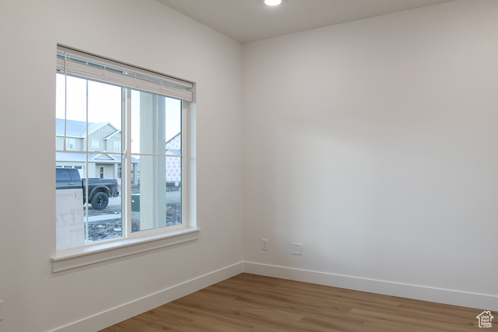Empty room with baseboards and wood finished floors