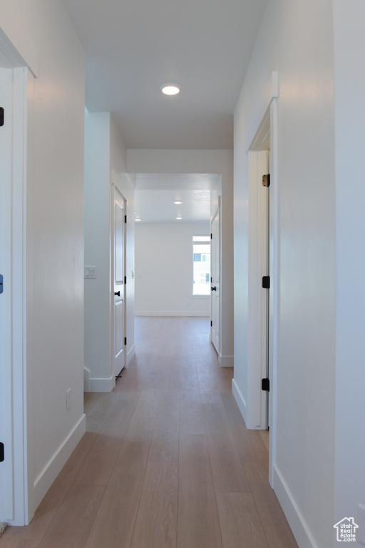 Hallway with recessed lighting and light wood-style floors