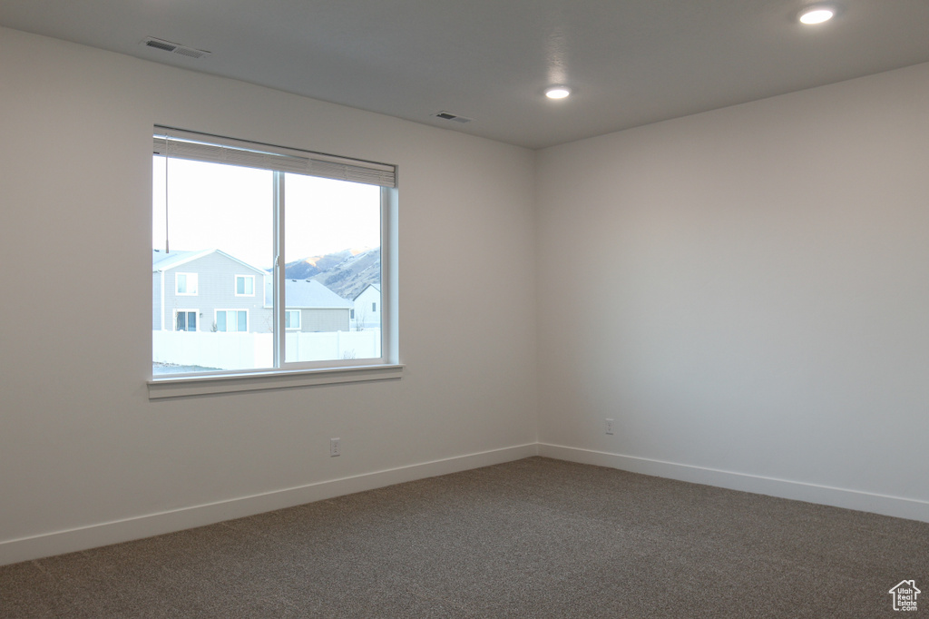 Empty room with carpet flooring, baseboards, and recessed lighting