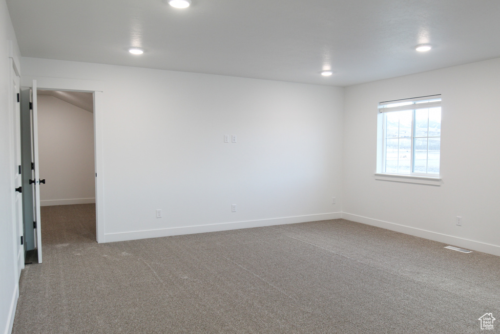Empty room featuring carpet, recessed lighting, and baseboards
