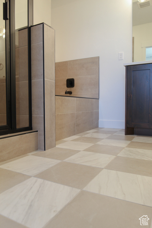 Bathroom featuring vanity and a shower
