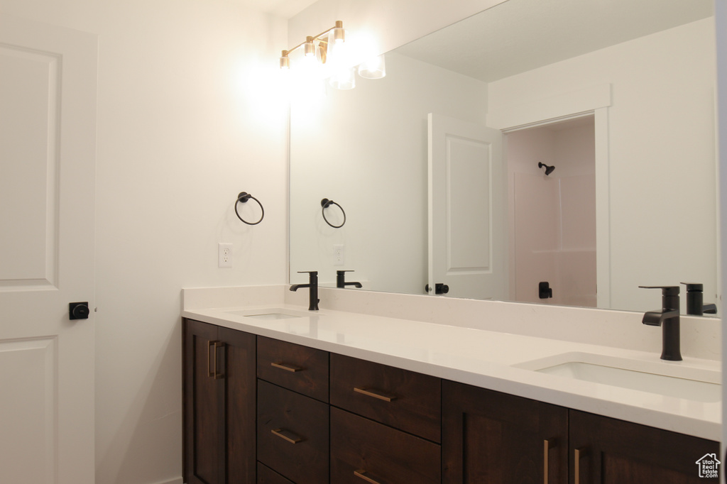 Full bath with double vanity and baseboards