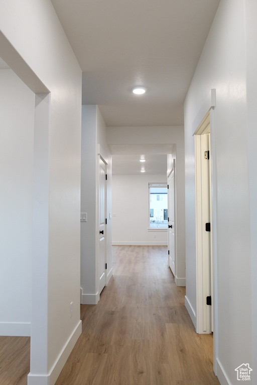 Hall featuring light wood finished floors and baseboards