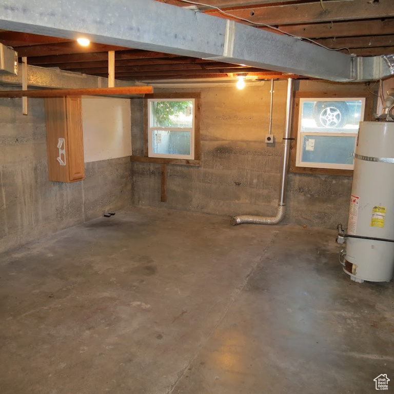 Below grade area featuring water heater