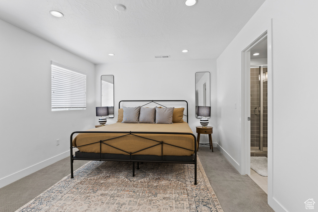 Bedroom featuring carpet, recessed lighting, baseboards, and connected bathroom