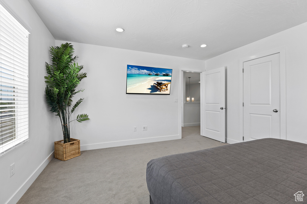 Carpeted bedroom with baseboards and recessed lighting