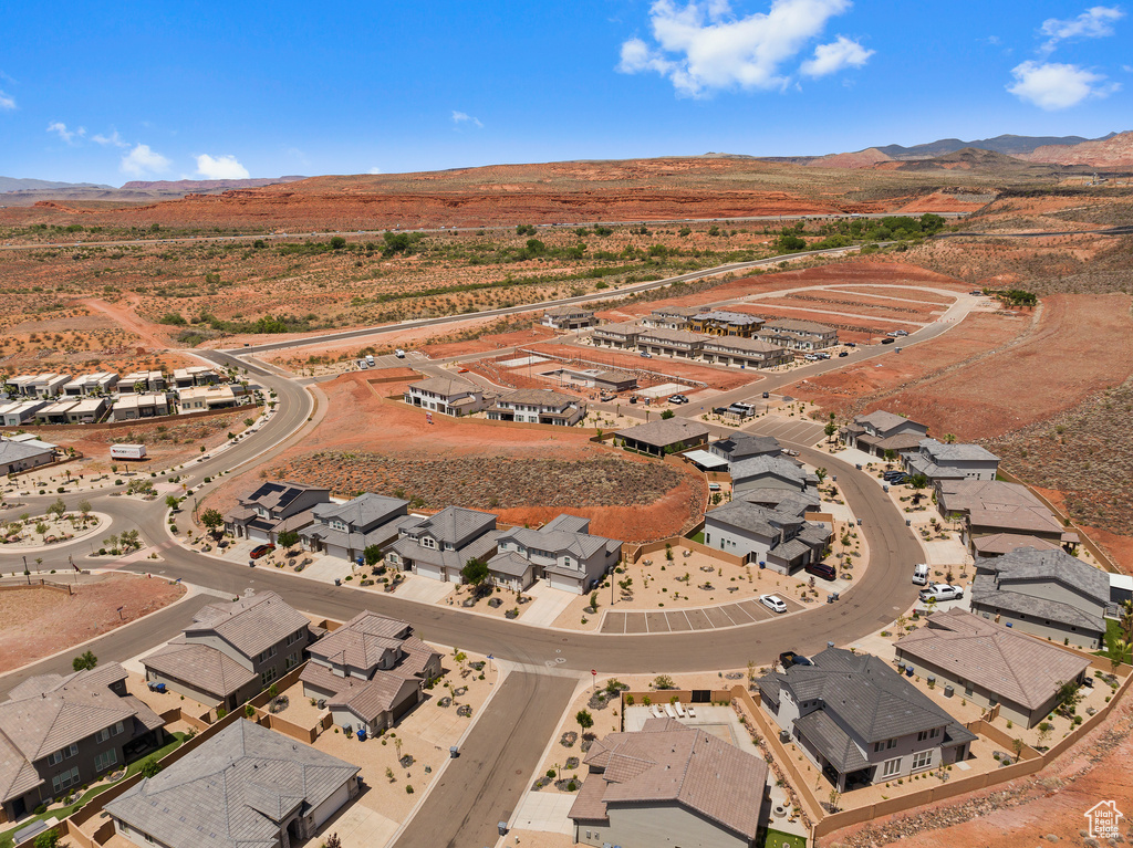 Aerial overview of property's location featuring a mountain backdrop and nearby suburban area