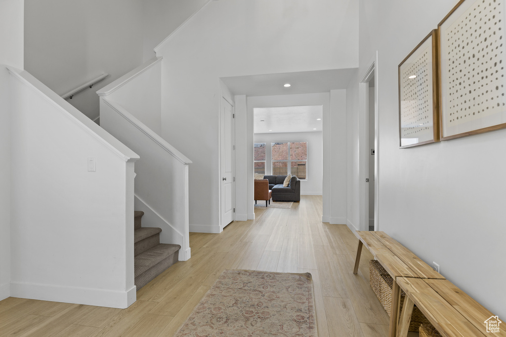 Entryway with light wood-style flooring, baseboards, stairway, and recessed lighting