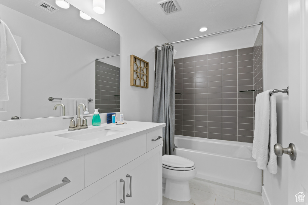 Full bath featuring tile patterned floors, toilet, shower / tub combo, and vanity