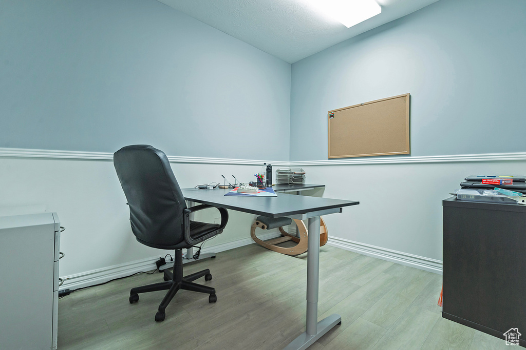 Home office featuring wood finished floors and baseboards