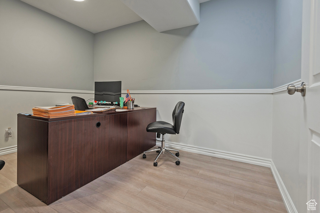 Office space with wood finished floors and baseboards