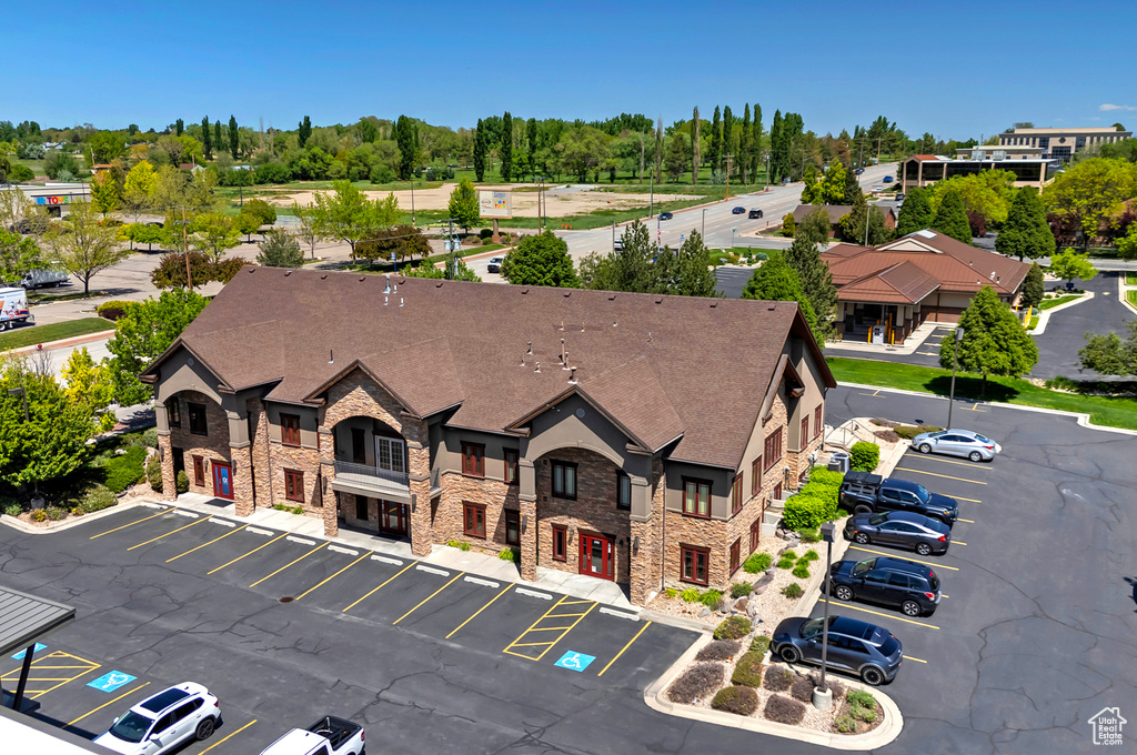 View of building exterior featuring uncovered parking