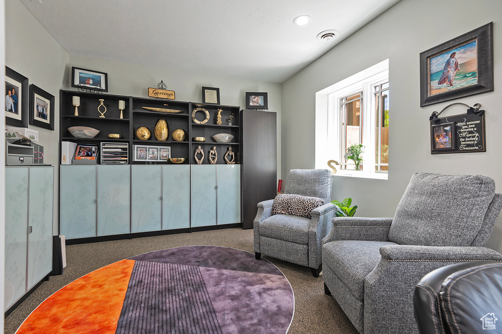 Living area featuring carpet floors and recessed lighting