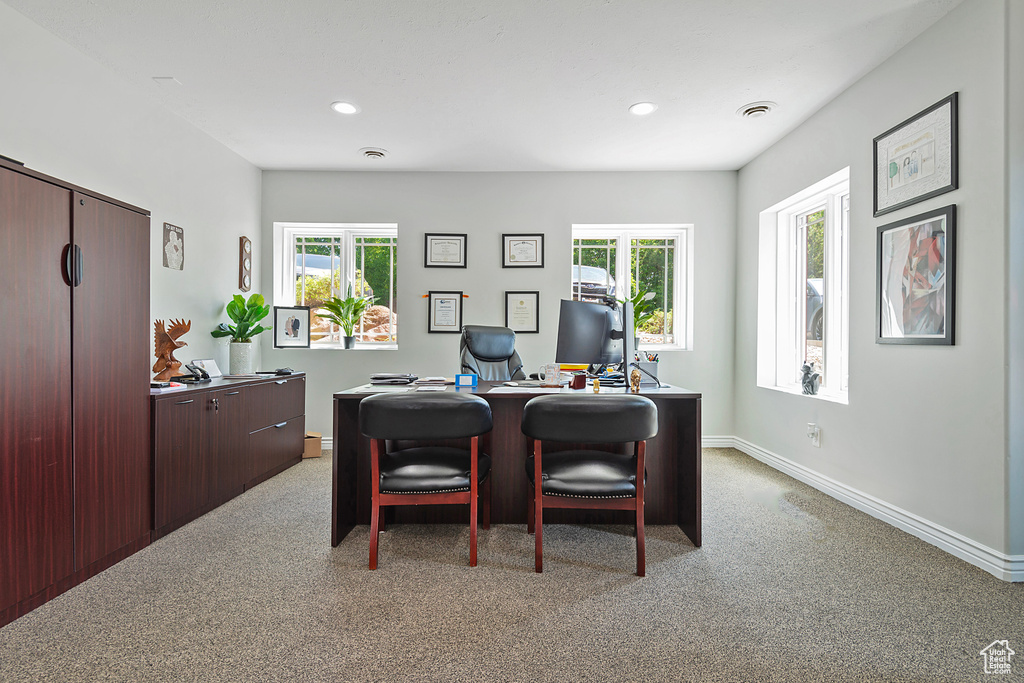 Office space with light colored carpet, baseboards, healthy amount of natural light, and recessed lighting