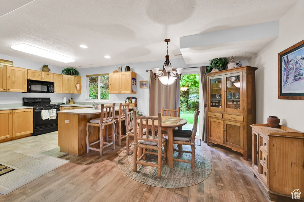 Dining room featuring a chandelier, light wood-type flooring, and recessed lighting