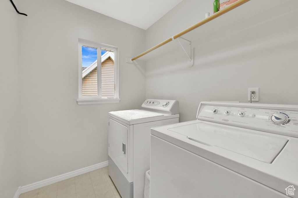 Laundry area with washing machine and dryer and baseboards