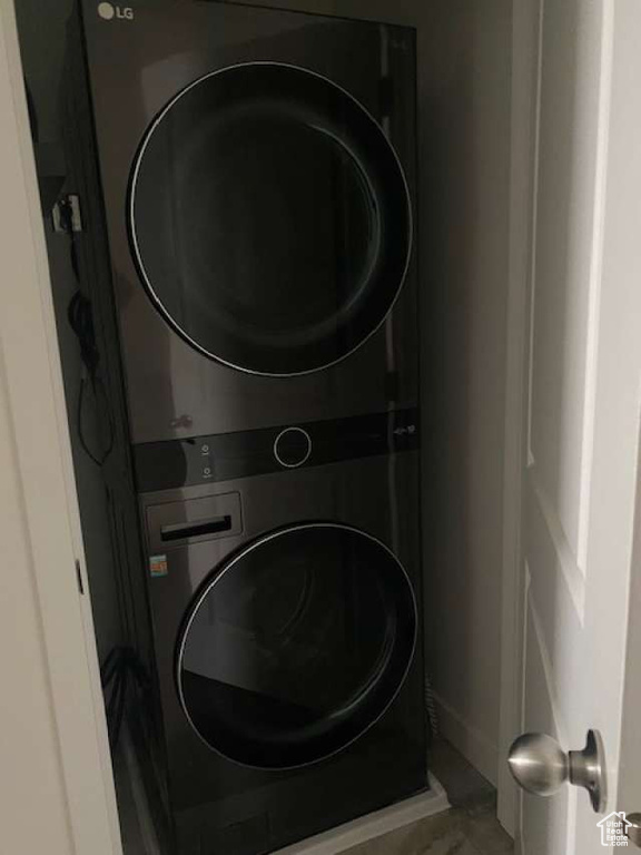 Washroom featuring stacked washer and clothes dryer
