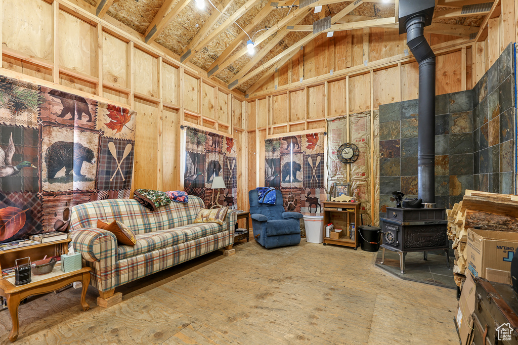 Living area with a wood stove and vaulted ceiling