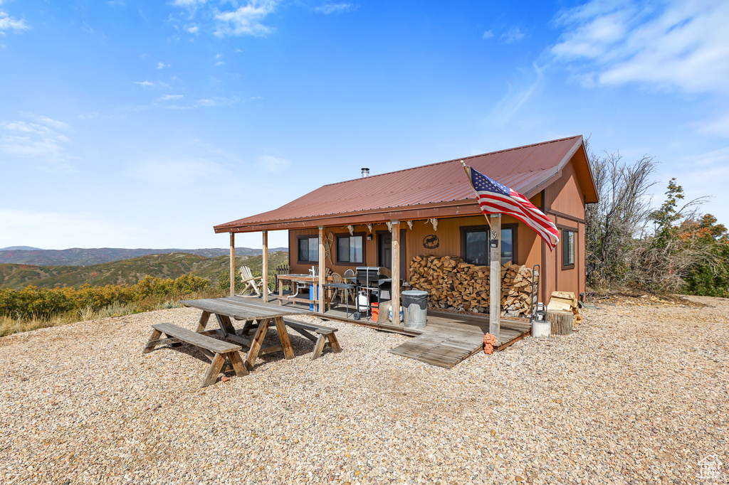 Back of property with metal roof and a mountain view