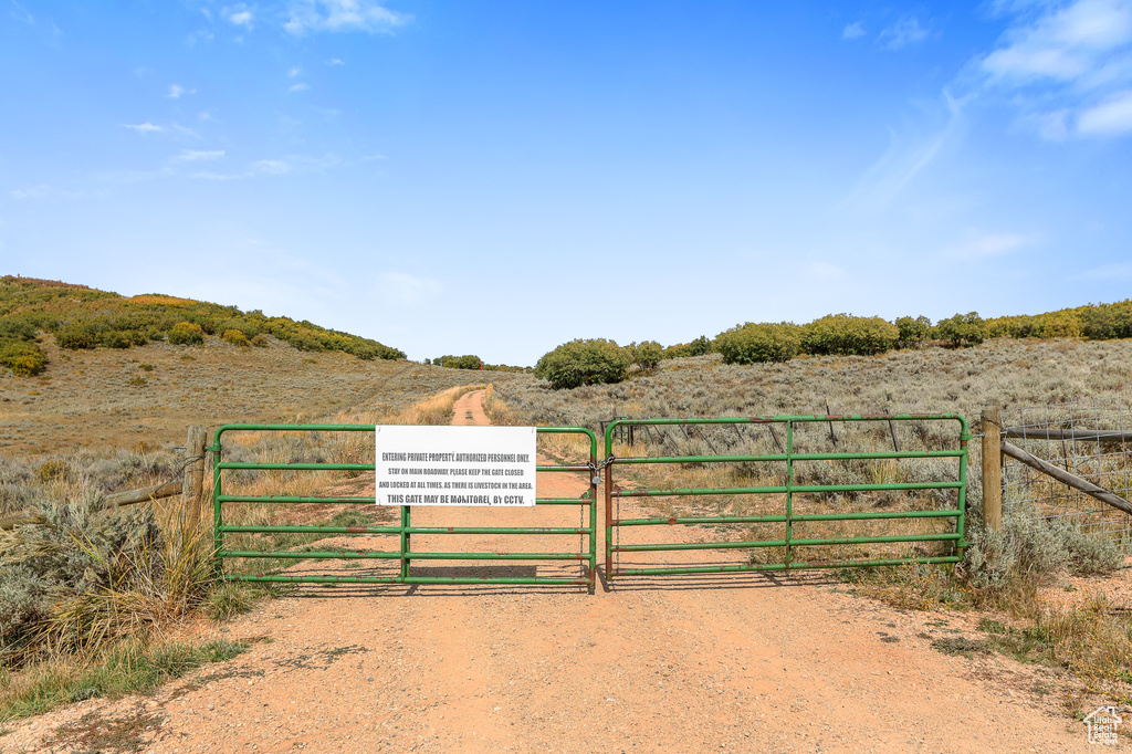 Gate featuring a view of rural / pastoral area and fence