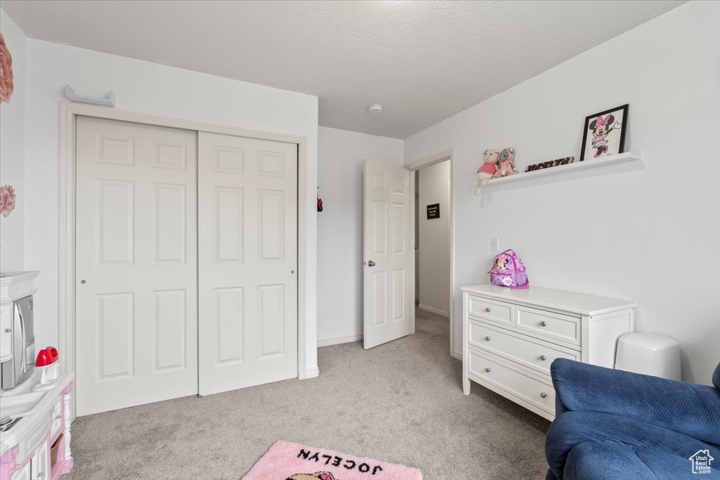 Living area featuring light carpet