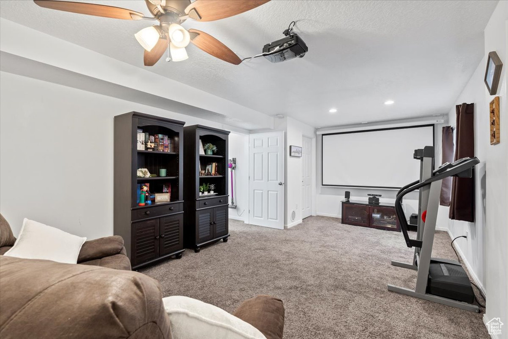 Home theater with carpet floors, a ceiling fan, baseboards, recessed lighting, and a textured ceiling
