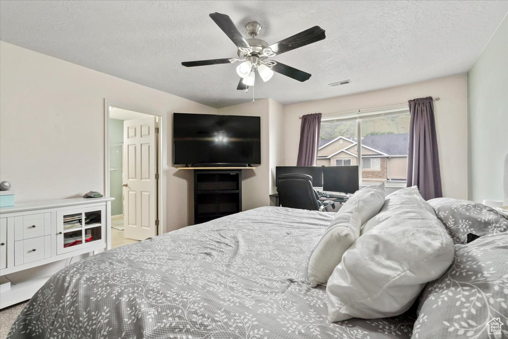 Bedroom featuring a textured ceiling and a ceiling fan