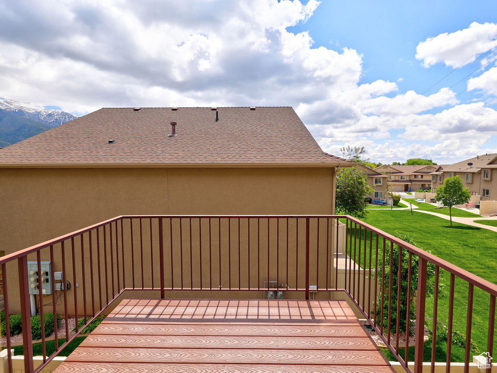 Wooden deck with a residential view and a lawn