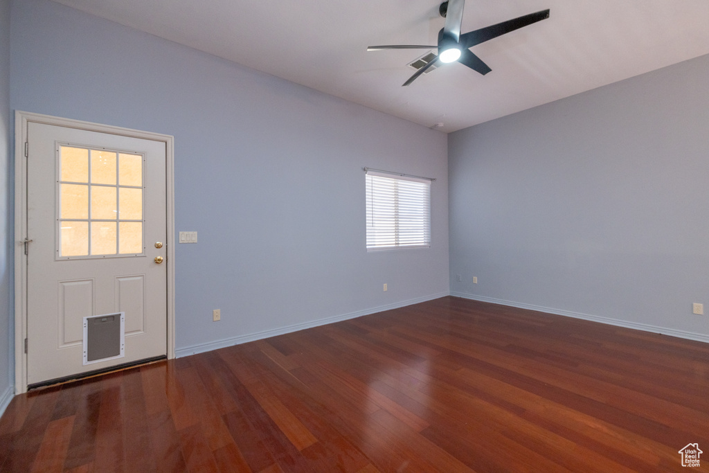 Spare room featuring ceiling fan, wood finished floors, and baseboards