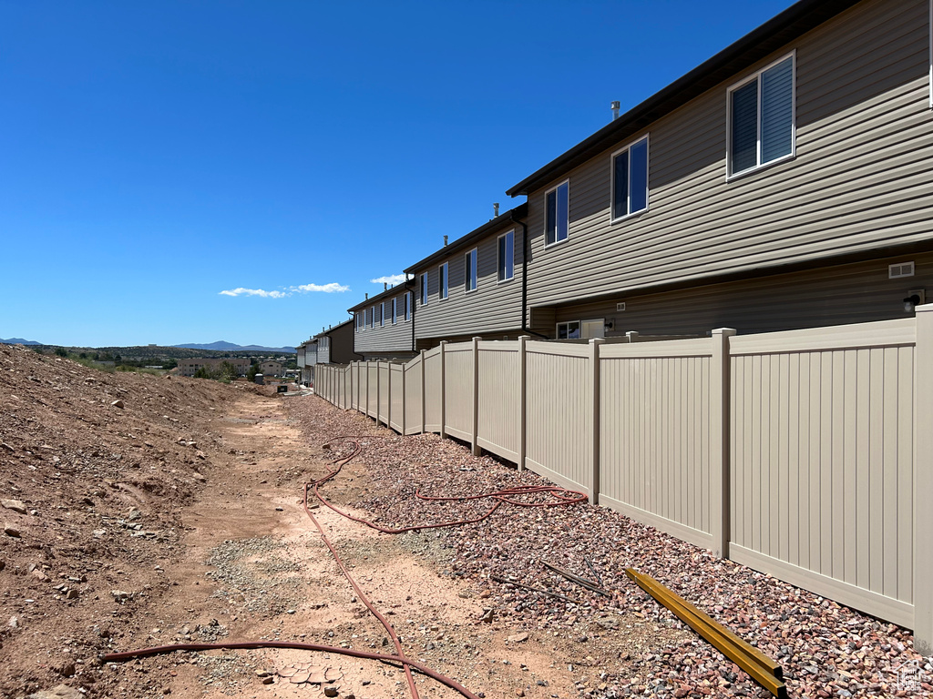 View of yard with fence and a mountain view