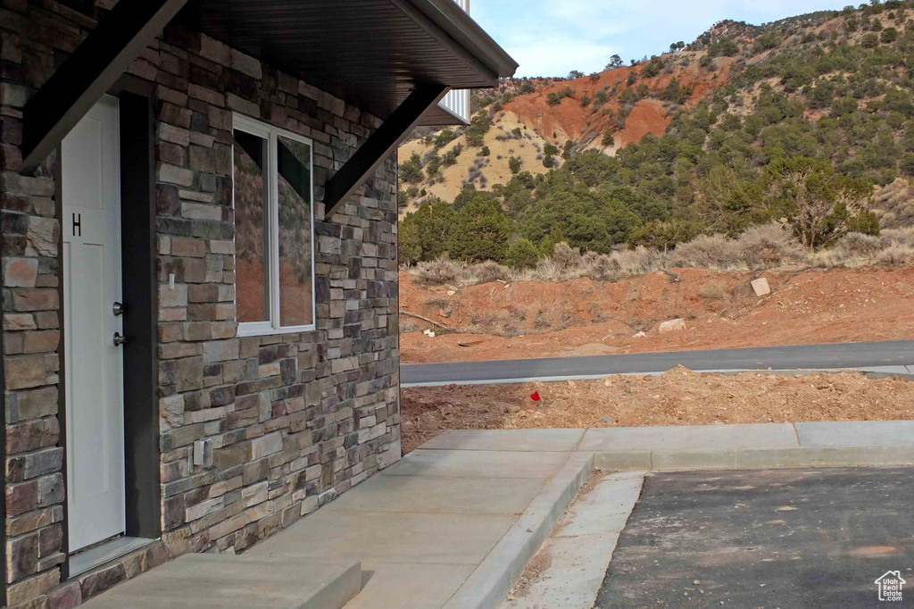 View of side of property with stone siding and a mountain view
