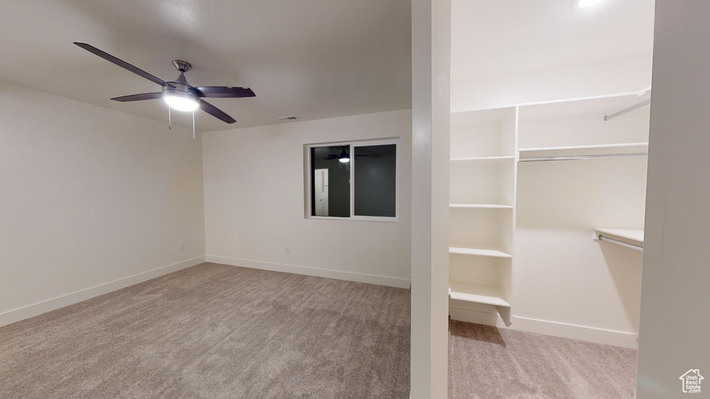 Unfurnished bedroom with carpet floors, baseboards, and a ceiling fan