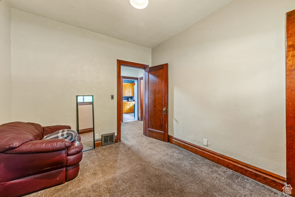 Sitting room featuring carpet floors and baseboards