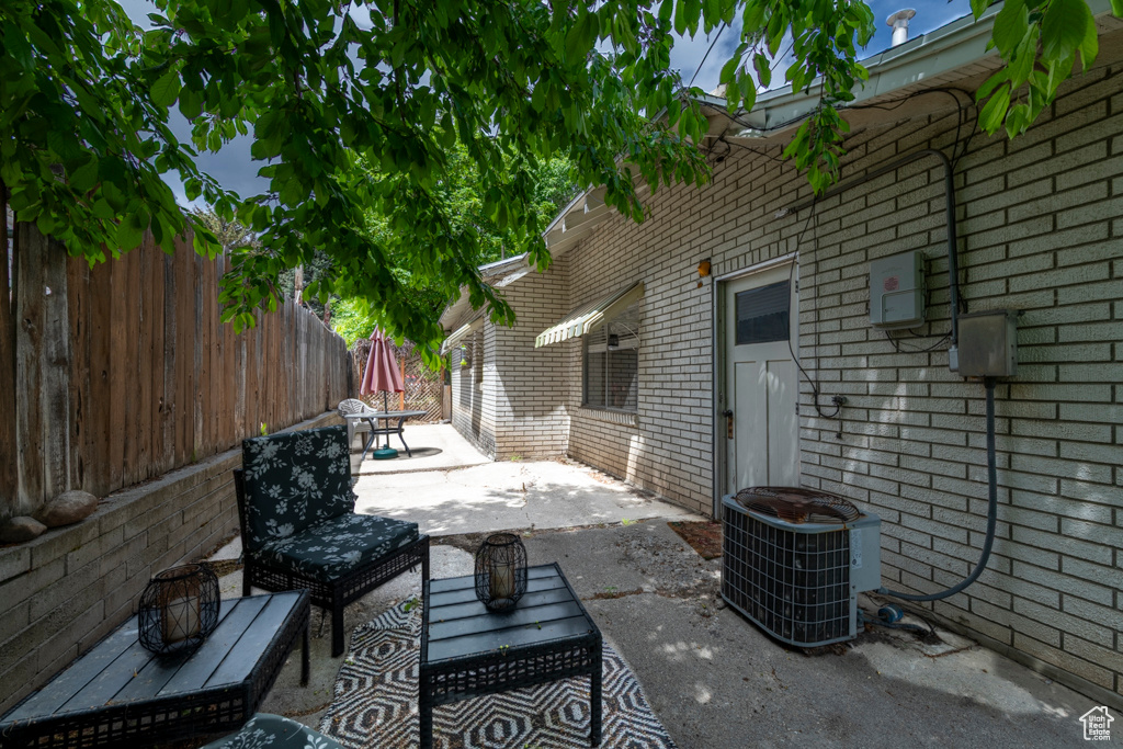 View of patio / terrace featuring central AC unit and fence