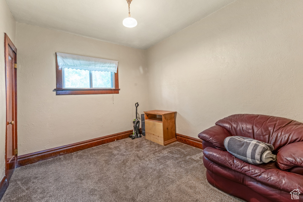 Sitting room featuring carpet flooring and baseboards