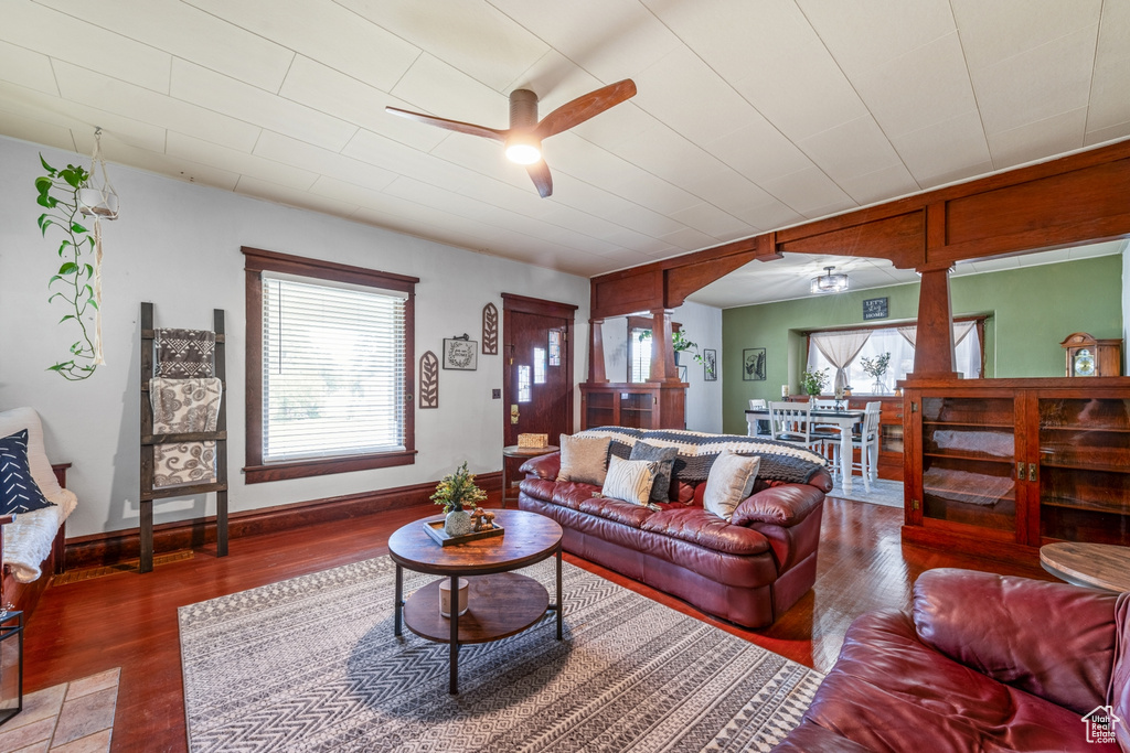 Living room featuring a ceiling fan, healthy amount of natural light, and wood finished floors