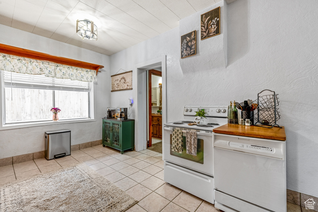 Kitchen featuring white appliances and light tile patterned floors
