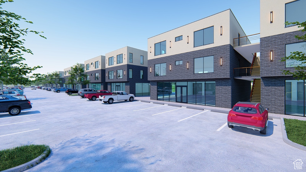 View of building exterior featuring uncovered parking