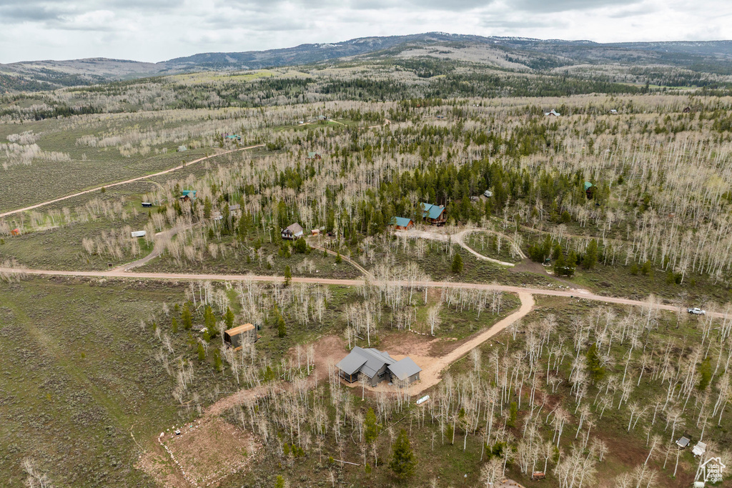 Aerial view of property's location featuring a mountain backdrop and rural landscape