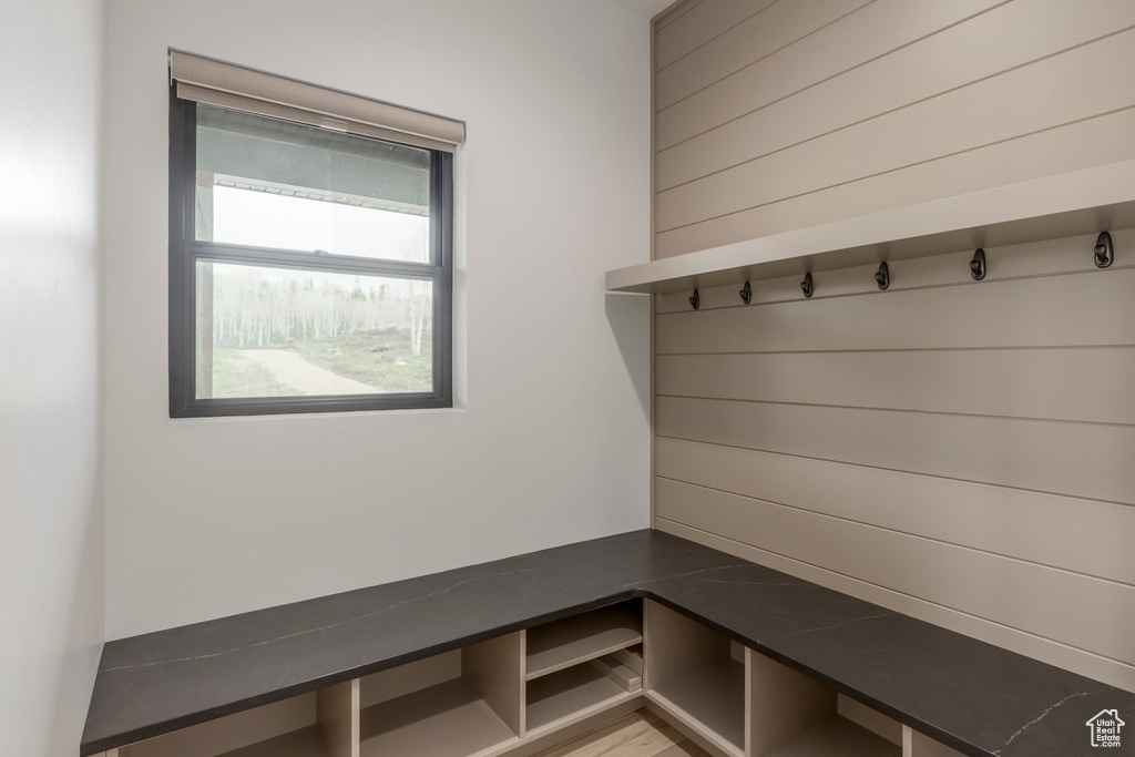 Mudroom featuring wooden walls