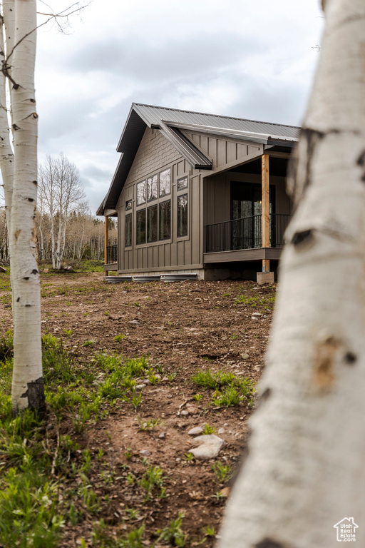 View of home's exterior featuring board and batten siding and metal roof