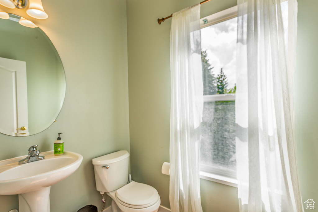 Half bathroom featuring a sink and toilet