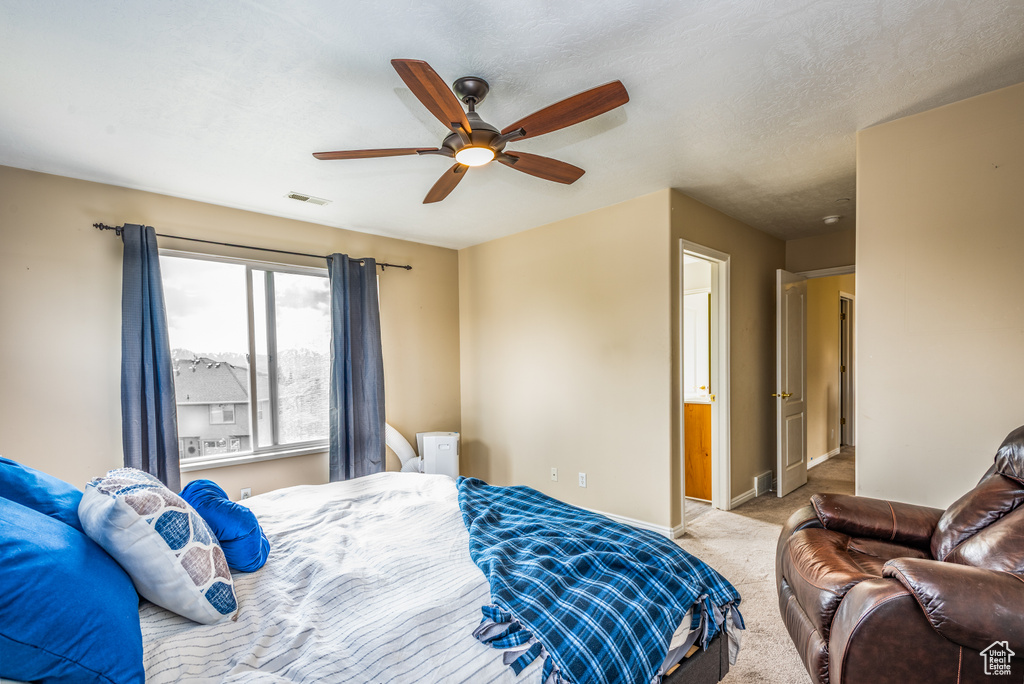 Carpeted bedroom with baseboards and a ceiling fan