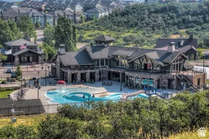 Outdoor pool featuring a patio and a residential view