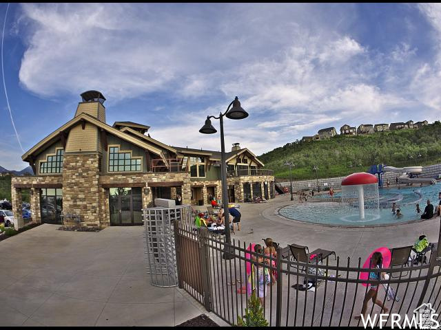 View of pool featuring fence and a patio
