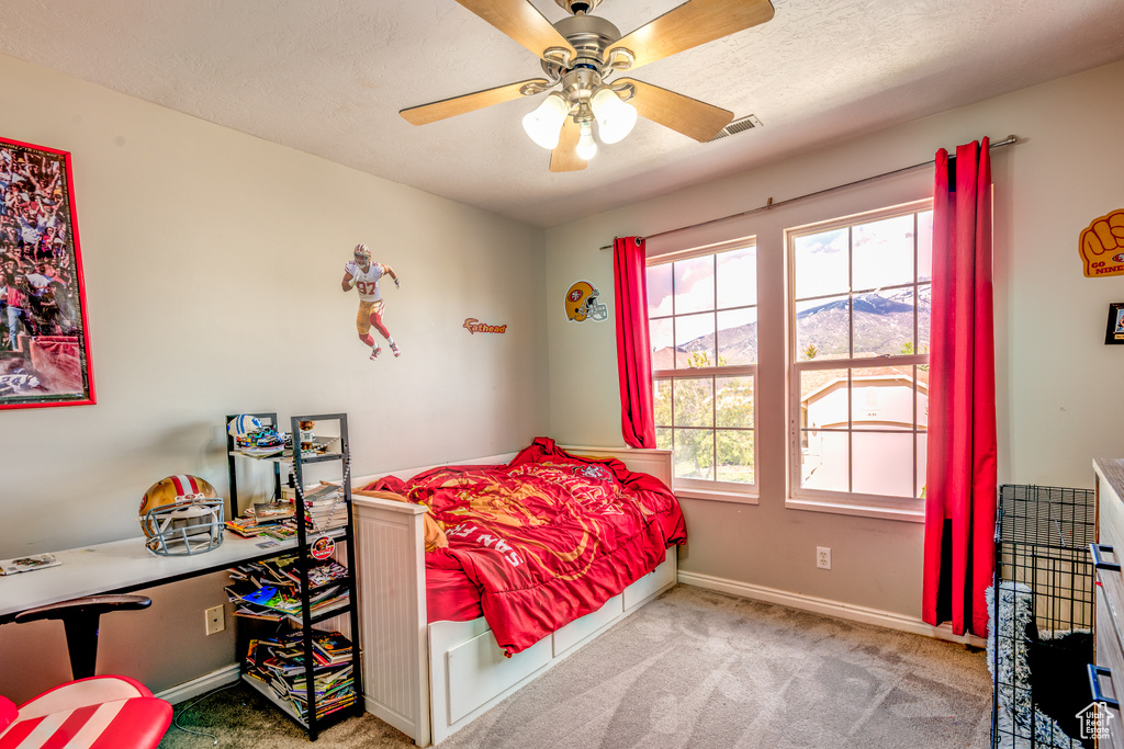 Bedroom featuring carpet flooring, baseboards, and ceiling fan