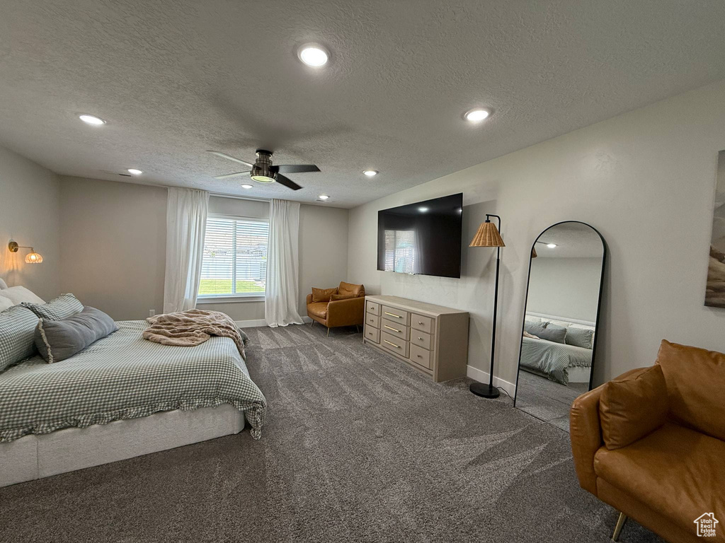 Bedroom featuring a textured ceiling, dark carpet, recessed lighting, ceiling fan, and baseboards