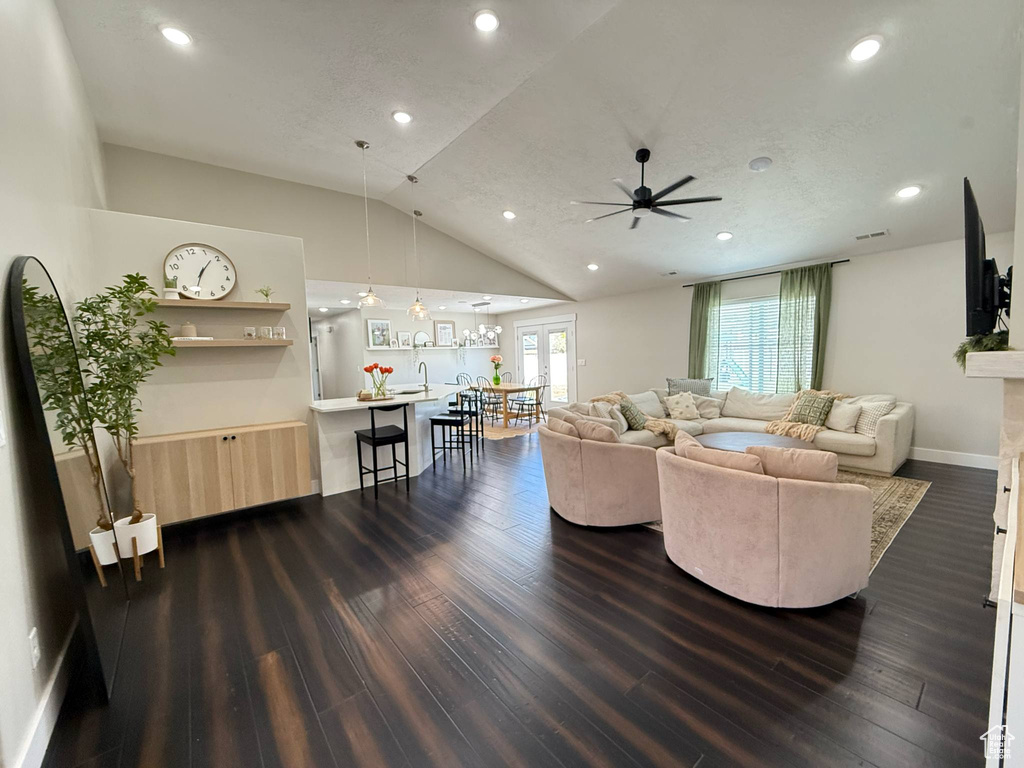 Living room with ceiling fan, dark wood finished floors, recessed lighting, lofted ceiling, and baseboards