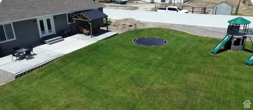 View of yard featuring french doors, a playground, and a patio